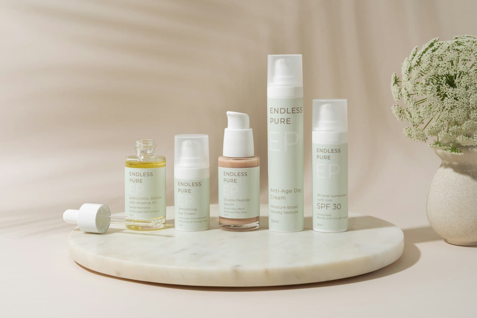 Skincare bottles on a round marble tray