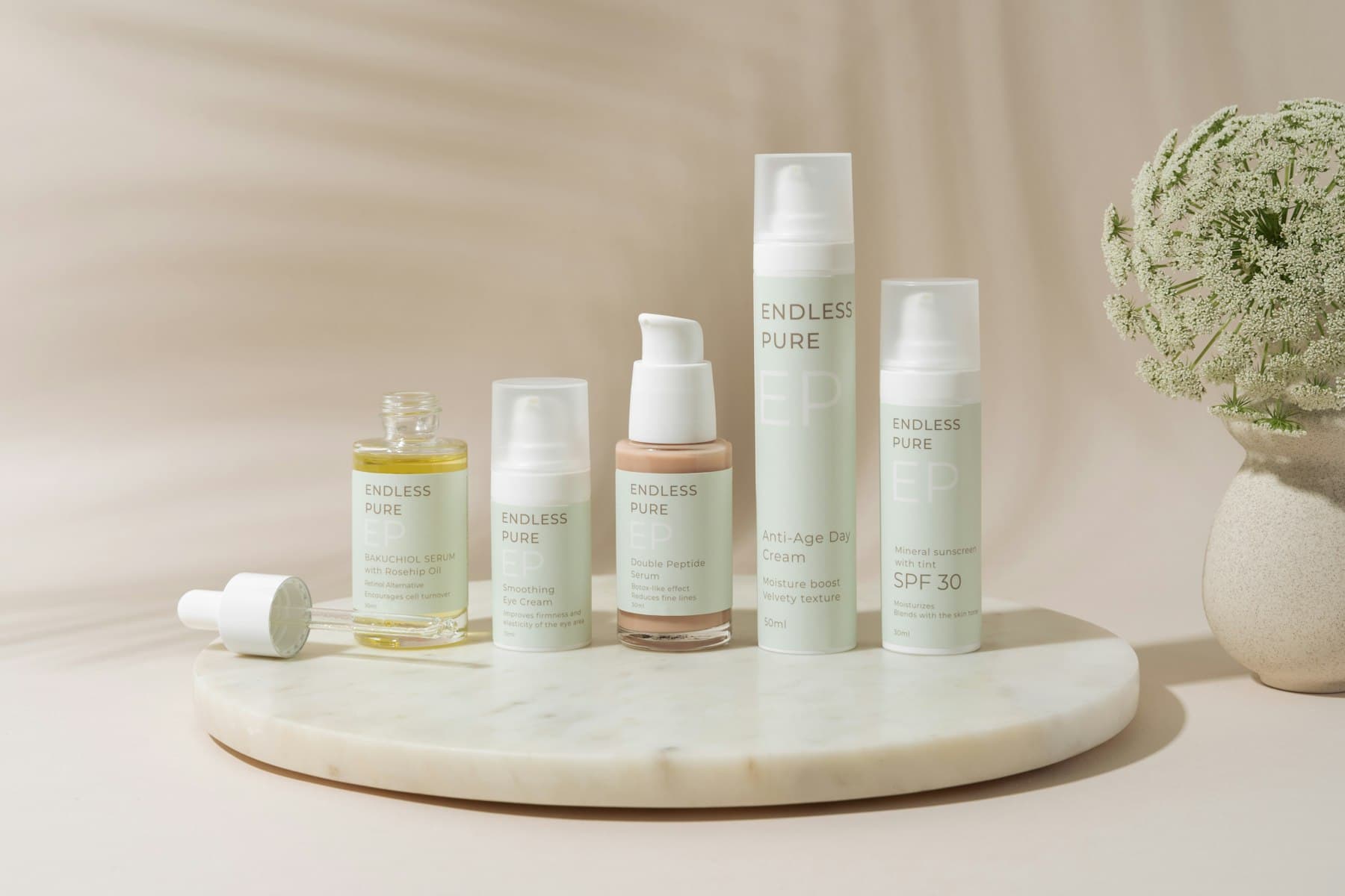 Skincare bottles on a round marble tray